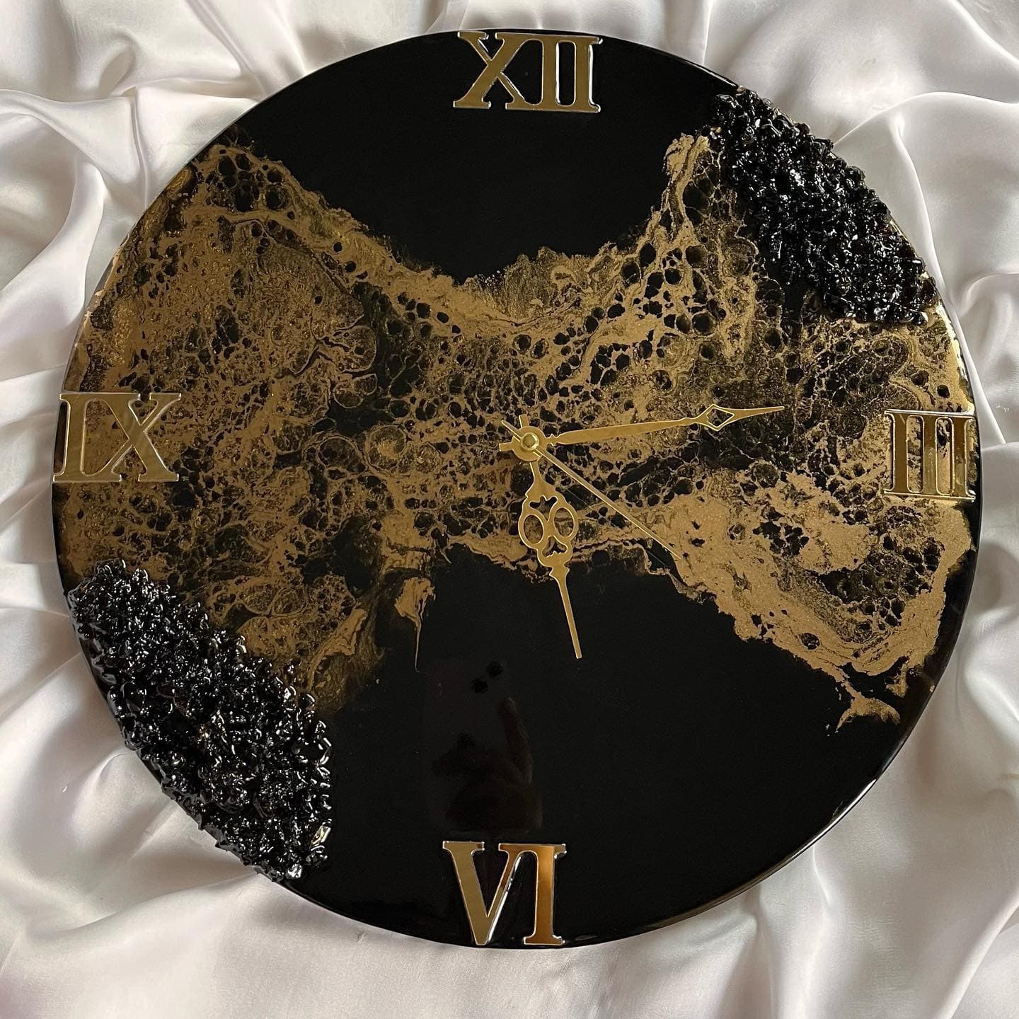 Cured black and gold resin surface polished to a mirror, reflecting the light