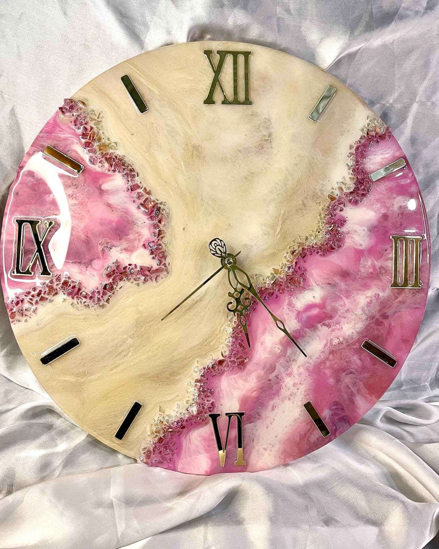 Cream and pink marbled resin surface with a crushed stone geode edge, part way to setting